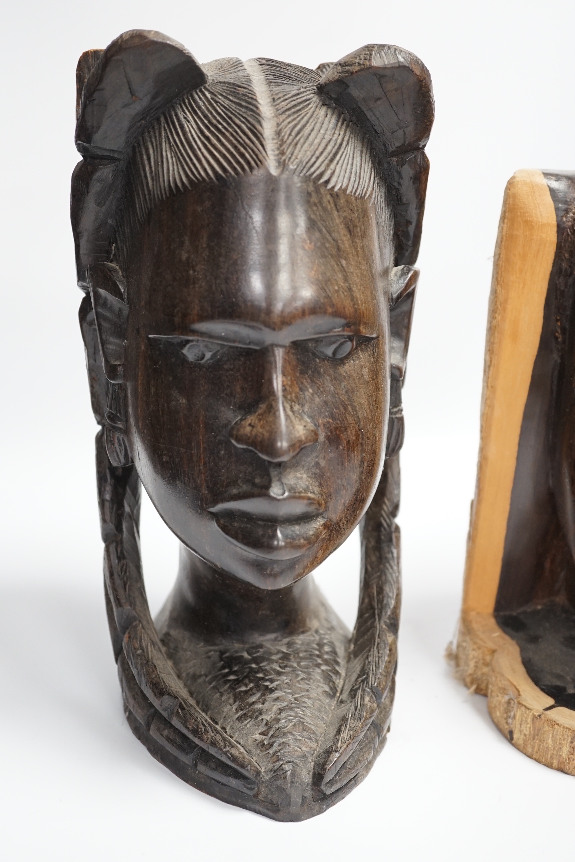 Two carved African ebony busts of a male and female, tallest 30cm high